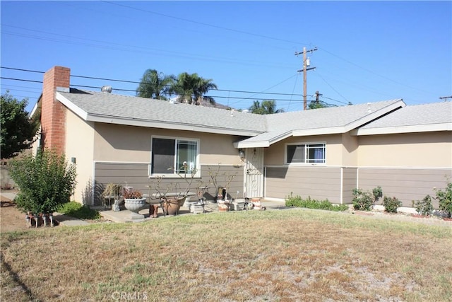 6400 Tournament Dr, Jurupa Valley, CA 92509 - ranch-style home with stucco siding, a front lawn, roof with shingles, and a chimney