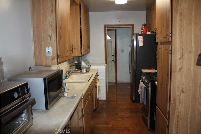 6400 Tournament Dr, Jurupa Valley, CA 92509 - kitchen with appliances with stainless steel finishes, light countertops, dark wood-style floors, and brown cabinetry