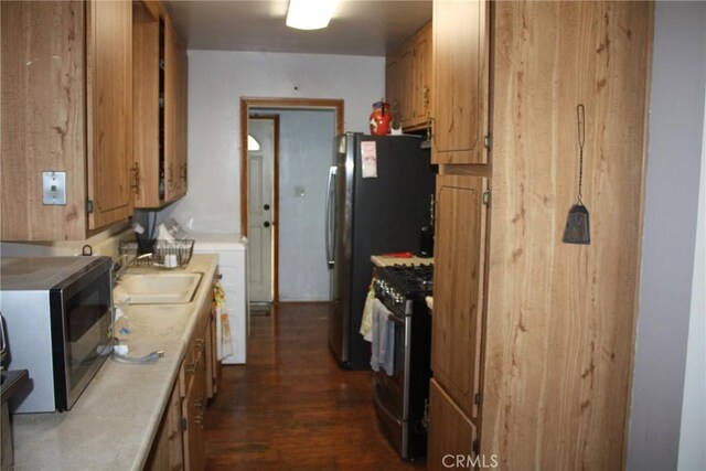 6400 Tournament Dr, Jurupa Valley, CA 92509 - kitchen with stainless steel gas range oven, light countertops, dark wood-style flooring, and brown cabinetry