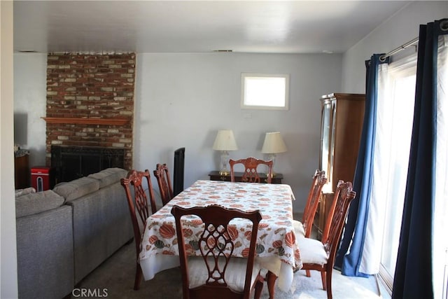 6400 Tournament Dr, Jurupa Valley, CA 92509 - carpeted dining space with a brick fireplace