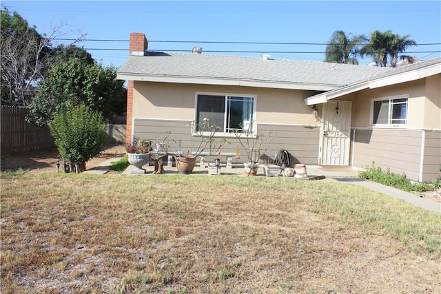 6400 Tournament Dr, Jurupa Valley, CA 92509 - back of house featuring a shingled roof, a chimney, and stucco siding