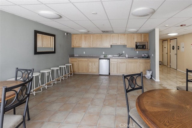 11124 Burbank Blvd Unit 101, North Hollywood, CA 91601 - kitchen with dishwasher, light brown cabinets, black microwave, a drop ceiling, and light tile patterned floors