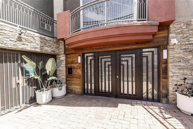 11124 Burbank Blvd Unit 101, North Hollywood, CA 91601 - doorway to property featuring a balcony, french doors, and stone siding