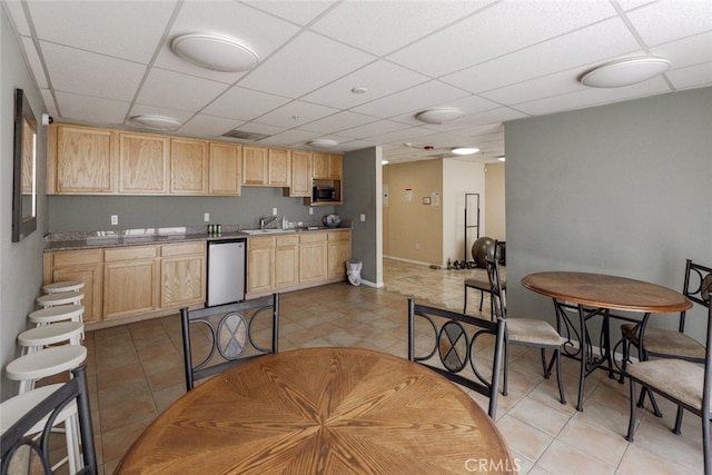 11124 Burbank Blvd Unit 101, North Hollywood, CA 91601 - kitchen featuring dishwasher, light brown cabinets, black microwave, a drop ceiling, and light tile patterned floors