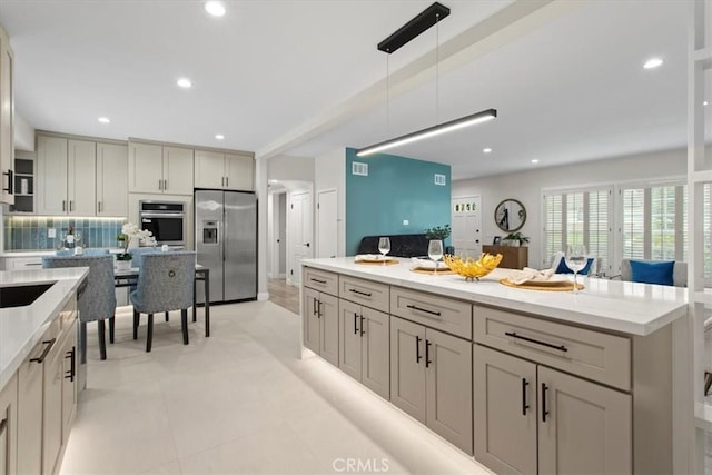 16842 Liggett St, Los Angeles, CA 91343 - kitchen featuring stainless steel appliances, pendant lighting, decorative backsplash, recessed lighting, and a center island