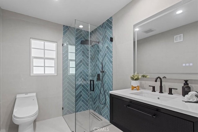 16842 Liggett St, Los Angeles, CA 91343 - bathroom with tile walls, vanity, a stall shower, and recessed lighting