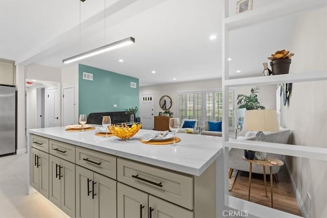 16842 Liggett St, Los Angeles, CA 91343 - kitchen with open floor plan, stainless steel refrigerator, light stone counters, decorative light fixtures, and recessed lighting