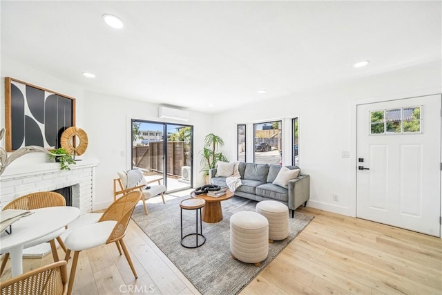 33871 Copper Lantern St, Dana Point, CA 92629 - living room featuring light wood-type flooring, a wall unit AC, a fireplace, and recessed lighting