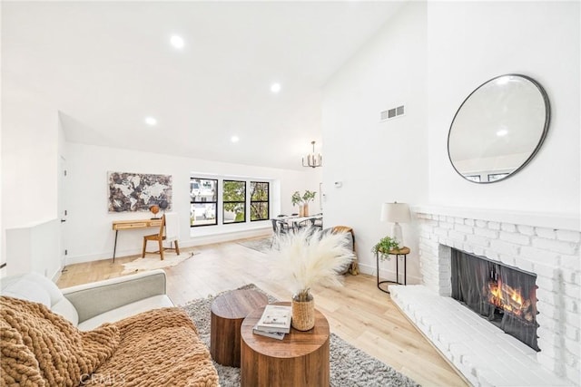 33871 Copper Lantern St, Dana Point, CA 92629 - living room featuring a brick fireplace, wood finished floors, recessed lighting, and high vaulted ceiling