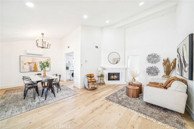 33871 Copper Lantern St, Dana Point, CA 92629 - living area featuring a chandelier, light wood-style flooring, a brick fireplace, high vaulted ceiling, and recessed lighting