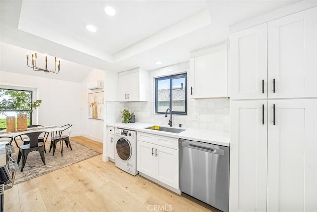33871 Copper Lantern St, Dana Point, CA 92629 - kitchen with stainless steel dishwasher, washer / clothes dryer, a tray ceiling, light countertops, and white cabinetry