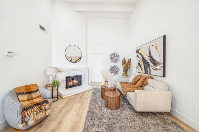 33871 Copper Lantern St, Dana Point, CA 92629 - living area featuring wood finished floors, a towering ceiling, a fireplace, and beam ceiling