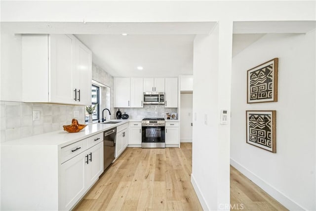 33871 Copper Lantern St, Dana Point, CA 92629 - kitchen featuring stainless steel appliances, light wood finished floors, tasteful backsplash, light countertops, and white cabinets