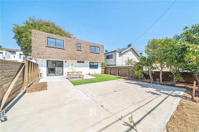 33871 Copper Lantern St, Dana Point, CA 92629 - rear view of house with a shingled roof, a patio, a fenced backyard, mansard roof, and stucco siding