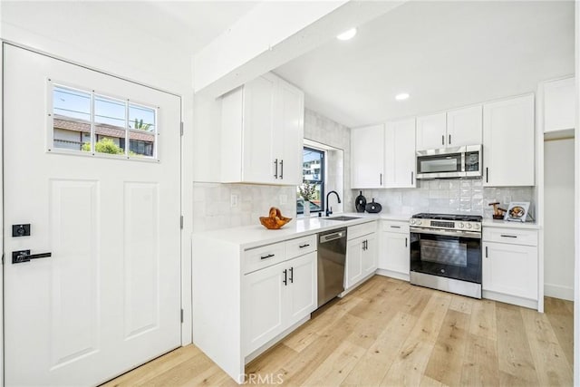 33871 Copper Lantern St, Dana Point, CA 92629 - kitchen with stainless steel appliances, light countertops, tasteful backsplash, light wood-type flooring, and recessed lighting