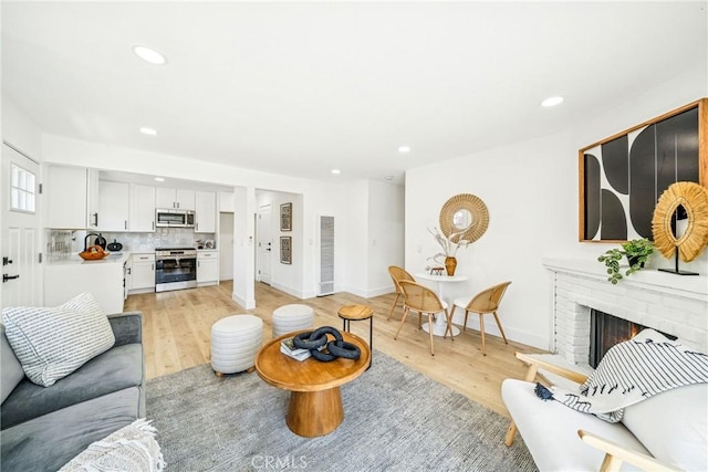 33871 Copper Lantern St, Dana Point, CA 92629 - living room with light wood-type flooring, recessed lighting, and a fireplace