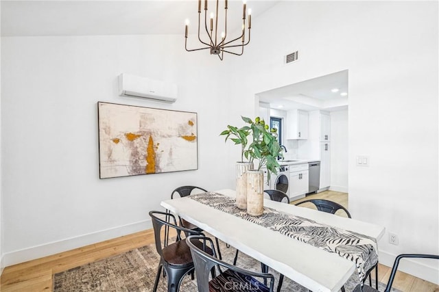 33871 Copper Lantern St, Dana Point, CA 92629 - dining room featuring a wall unit AC, a chandelier, and light wood finished floors