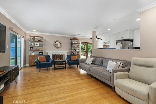 5055 Blanchard Dr, Riverside, CA 92504 - living room with a brick fireplace, light wood-style floors, ornamental molding, recessed lighting, and ceiling fan