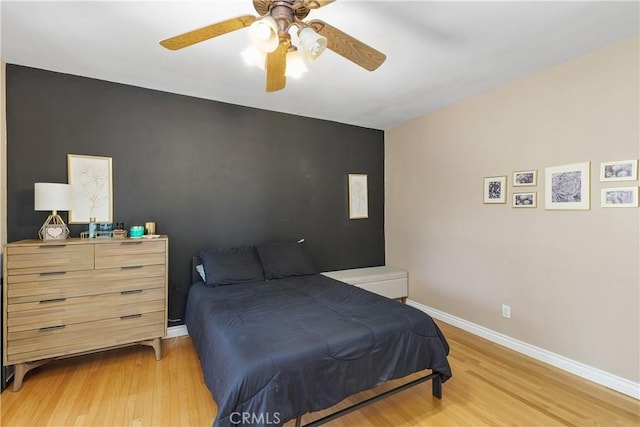 5055 Blanchard Dr, Riverside, CA 92504 - bedroom with light wood finished floors, ceiling fan, and an accent wall