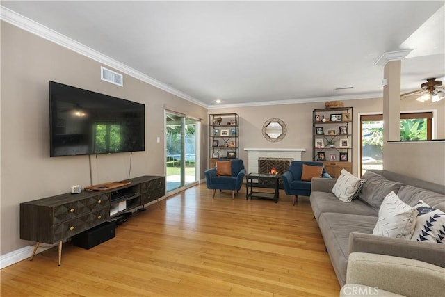 5055 Blanchard Dr, Riverside, CA 92504 - living area featuring light wood-style floors, a fireplace, crown molding, and a ceiling fan