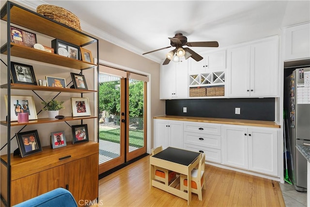 5055 Blanchard Dr, Riverside, CA 92504 - kitchen featuring crown molding, ceiling fan, white cabinetry, and light wood-style flooring