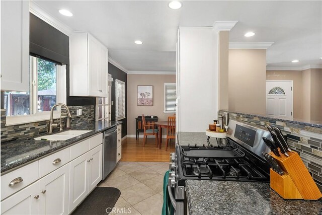 5055 Blanchard Dr, Riverside, CA 92504 - kitchen with stainless steel appliances, backsplash, white cabinetry, recessed lighting, and dark stone countertops