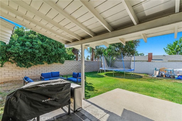 5055 Blanchard Dr, Riverside, CA 92504 - fenced backyard featuring a patio area, a trampoline, area for grilling, and an outdoor hangout area