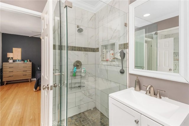 5055 Blanchard Dr, Riverside, CA 92504 - bathroom featuring a stall shower, vanity, ornamental molding, wood finished floors, and recessed lighting