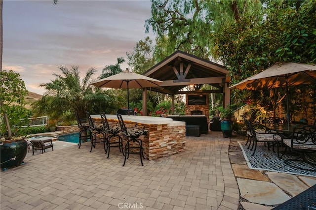 9911 Overhill Dr, North Tustin, CA 92705 - view of patio / terrace featuring a gazebo, an outdoor stone fireplace, and an outdoor pool