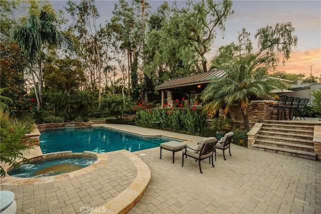 9911 Overhill Dr, North Tustin, CA 92705 - pool at dusk with a patio area and a pool with connected hot tub