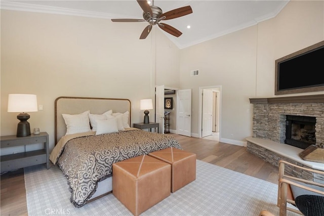 9911 Overhill Dr, North Tustin, CA 92705 - bedroom with crown molding, wood finished floors, a stone fireplace, high vaulted ceiling, and a ceiling fan