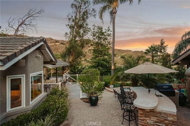 9911 Overhill Dr, North Tustin, CA 92705 - patio terrace at dusk with a patio area and a mountain view