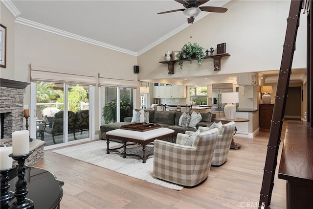 9911 Overhill Dr, North Tustin, CA 92705 - living room featuring high vaulted ceiling, ceiling fan, light wood-type flooring, crown molding, and a stone fireplace