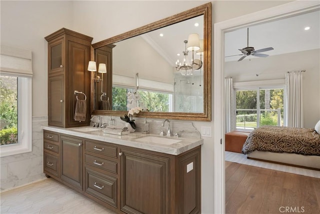 9911 Overhill Dr, North Tustin, CA 92705 - ensuite bathroom featuring lofted ceiling, healthy amount of natural light, double vanity, a chandelier, and a ceiling fan