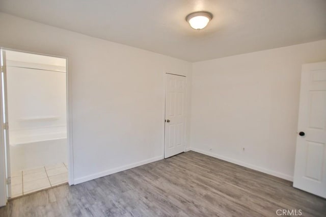 531 W 61st St, Los Angeles, CA 90044 - unfurnished bedroom with wood finished floors and baseboards