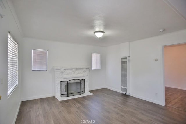 531 W 61st St, Los Angeles, CA 90044 - unfurnished living room with a heating unit, wood finished floors, and plenty of natural light