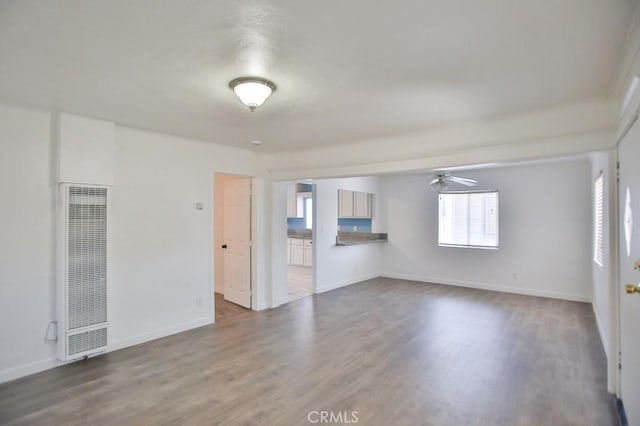 531 W 61st St, Los Angeles, CA 90044 - unfurnished room featuring a heating unit, ceiling fan, and wood finished floors