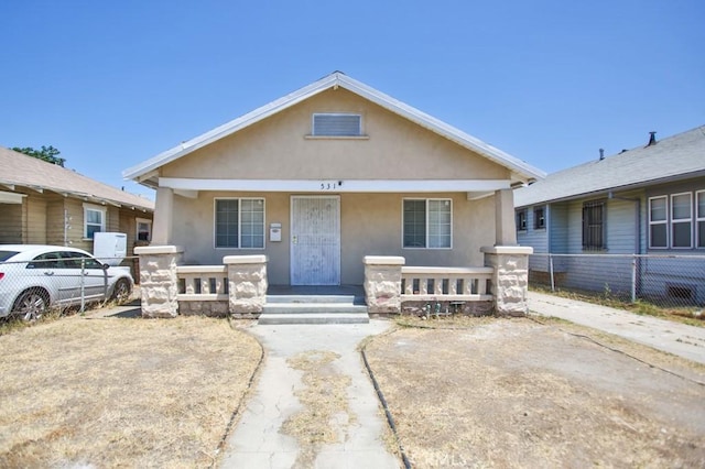531 W 61st St, Los Angeles, CA 90044 - bungalow-style home featuring covered porch and stucco siding