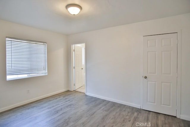 531 W 61st St, Los Angeles, CA 90044 - empty room with wood finished floors and baseboards