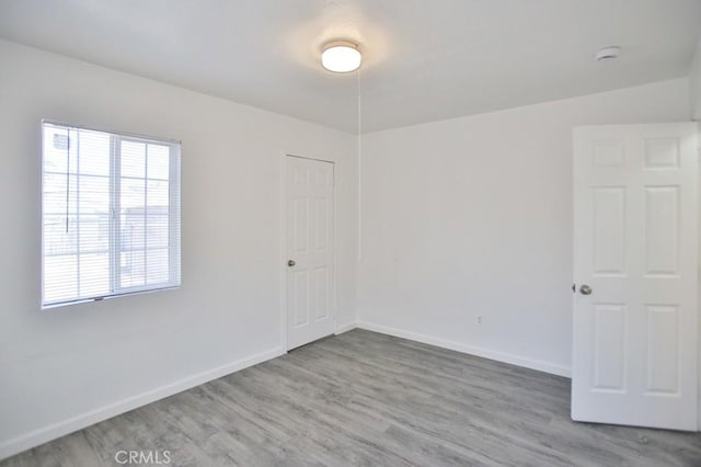 531 W 61st St, Los Angeles, CA 90044 - empty room featuring wood finished floors and a smoke detector