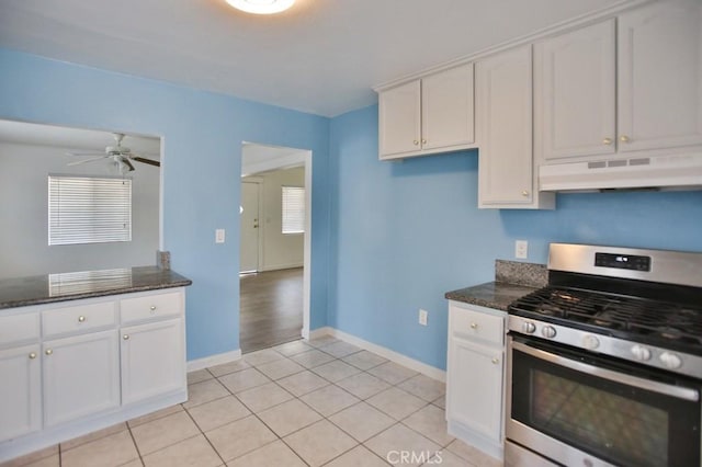 531 W 61st St, Los Angeles, CA 90044 - kitchen featuring stainless steel gas stove, under cabinet range hood, white cabinets, dark stone countertops, and a ceiling fan