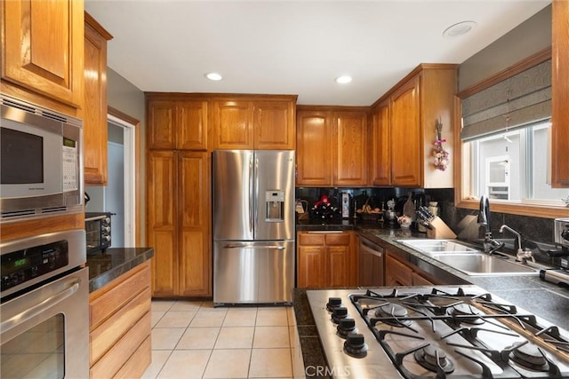 729 Longfellow Ave, Hermosa Beach, CA 90254 - kitchen with stainless steel appliances, brown cabinets, light tile patterned floors, recessed lighting, and tasteful backsplash