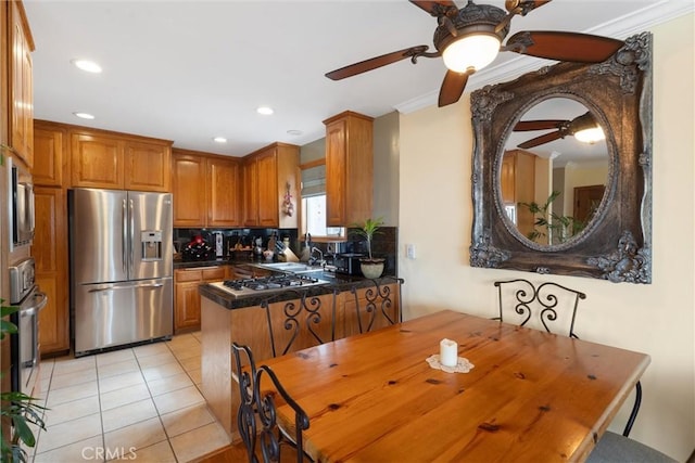 729 Longfellow Ave, Hermosa Beach, CA 90254 - kitchen with stainless steel appliances, ceiling fan, brown cabinets, a peninsula, and ornamental molding