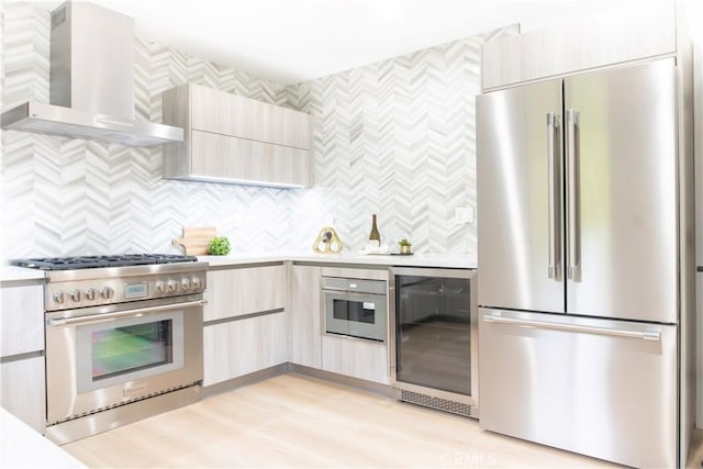 539 Avon Ave, Pasadena, CA 91105 - kitchen featuring appliances with stainless steel finishes, wall chimney range hood, wine cooler, light countertops, and modern cabinets
