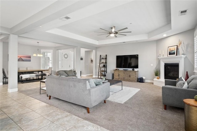 3109 Rae Creek Dr, Chico, CA 95973 - living area featuring a raised ceiling, ceiling fan, a chandelier, a glass covered fireplace, and recessed lighting