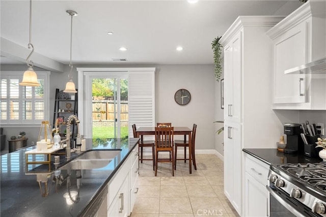 3109 Rae Creek Dr, Chico, CA 95973 - kitchen with wall chimney range hood, white cabinetry, light tile patterned flooring, recessed lighting, and dark stone countertops