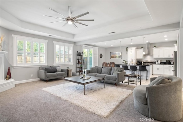 3109 Rae Creek Dr, Chico, CA 95973 - living area featuring a raised ceiling, a ceiling fan, recessed lighting, and light colored carpet
