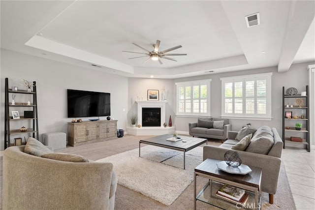 3109 Rae Creek Dr, Chico, CA 95973 - living area with a raised ceiling, a ceiling fan, a glass covered fireplace, and light tile patterned flooring