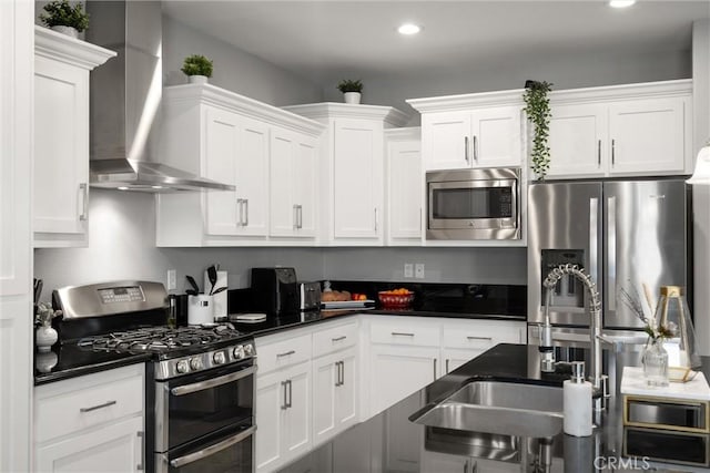 3109 Rae Creek Dr, Chico, CA 95973 - kitchen featuring appliances with stainless steel finishes, wall chimney range hood, white cabinetry, dark countertops, and recessed lighting