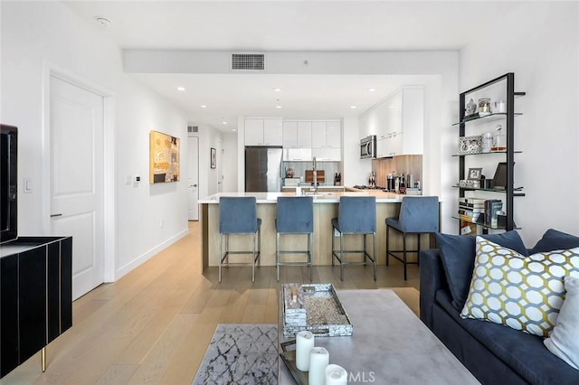 400 S Broadway Unit 1701, Los Angeles, CA 90013 - living room featuring light wood-style floors and recessed lighting